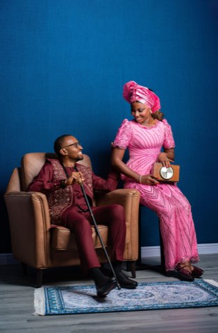 Akachi laughing beside Sommie in traditional dress